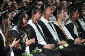 Nikiski graduates view their slideshow during a commencement ceremony at Nikiski/Middle High School in Nikiski, Alaska, on Monday, May 19, 2025. (Jake Dye/Peninsula Clarion)