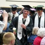 Nikiski senior class president Oliver Parrish brings a rose to one of his supporters during a commencement ceremony at Nikiski/Middle High School in Nikiski, Alaska, on Monday, May 19, 2025. (Jake Dye/Peninsula Clarion)