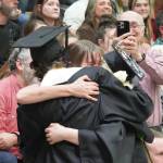 Nikiski graduates bring roses to one of their supporters, teacher Carla Jenness, during a commencement ceremony at Nikiski/Middle High School in Nikiski, Alaska, on Monday, May 19, 2025. (Jake Dye/Peninsula Clarion)