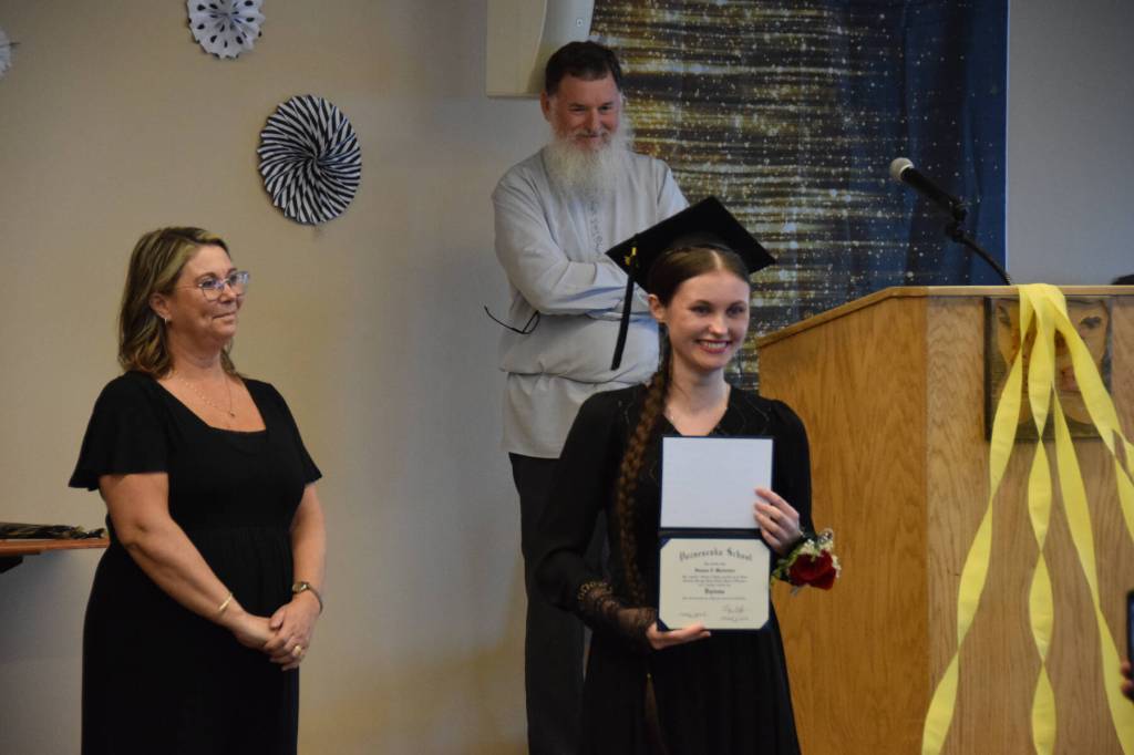 Susana Martushev holds up her diploma during the Voznesenka School commencement ceremony held Monday, May 19, 2025, at Lands End Resort in Homer, Alaska. (Delcenia Cosman/Homer News)