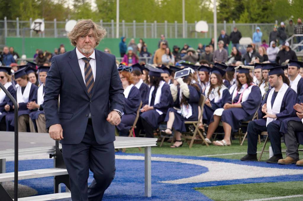 Commencement speaker Sarge Truesdell of Soldotna High School steps down from the stage after delivering a commencement address to graduates of Soldotna High School on the schools football field in Soldotna, Alaska, on Wednesday, May 21, 2025. (Jake Dye/Peninsula Clarion)