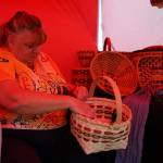Carolyn Jennings, of Weavin and Things, crafts baskets during Saturday Market at the Goods in Soldotna, Alaska, on Saturday, June 14, 2025. (Jake Dye/Peninsula Clarion)