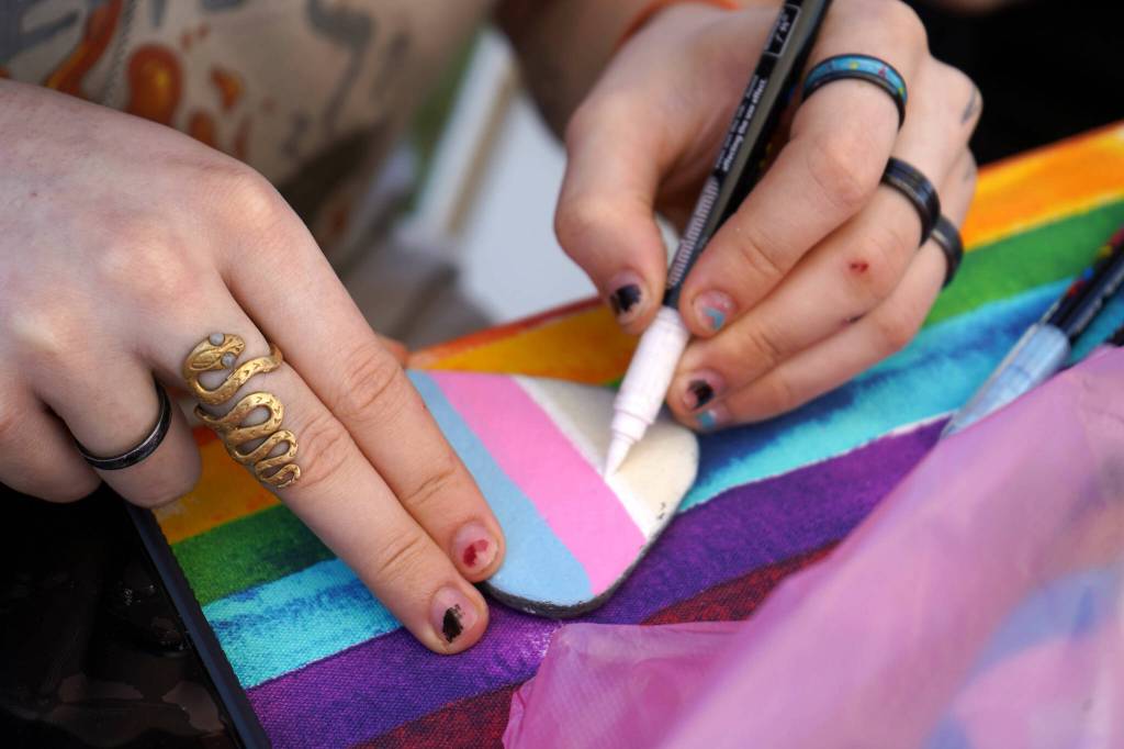 People paint rocks during Saturday Market at the Goods in Soldotna, Alaska, on Saturday, June 14, 2025. (Jake Dye/Peninsula Clarion)