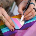 People paint rocks during Saturday Market at the Goods in Soldotna, Alaska, on Saturday, June 14, 2025. (Jake Dye/Peninsula Clarion)