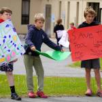 Swimmers and parents protest the proposed closure of Kenai Peninsula Borough School District pools outside of the Kenai Peninsula Borough Administration Building in Soldotna, Alaska, on Thursday, June 26, 2025. (Jake Dye/Peninsula Clarion)