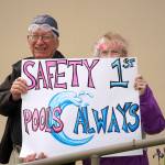 Swimmers and parents protest the proposed closure of Kenai Peninsula Borough School District pools outside of the Kenai Peninsula Borough Administration Building in Soldotna, Alaska, on Thursday, June 26, 2025. (Jake Dye/Peninsula Clarion)