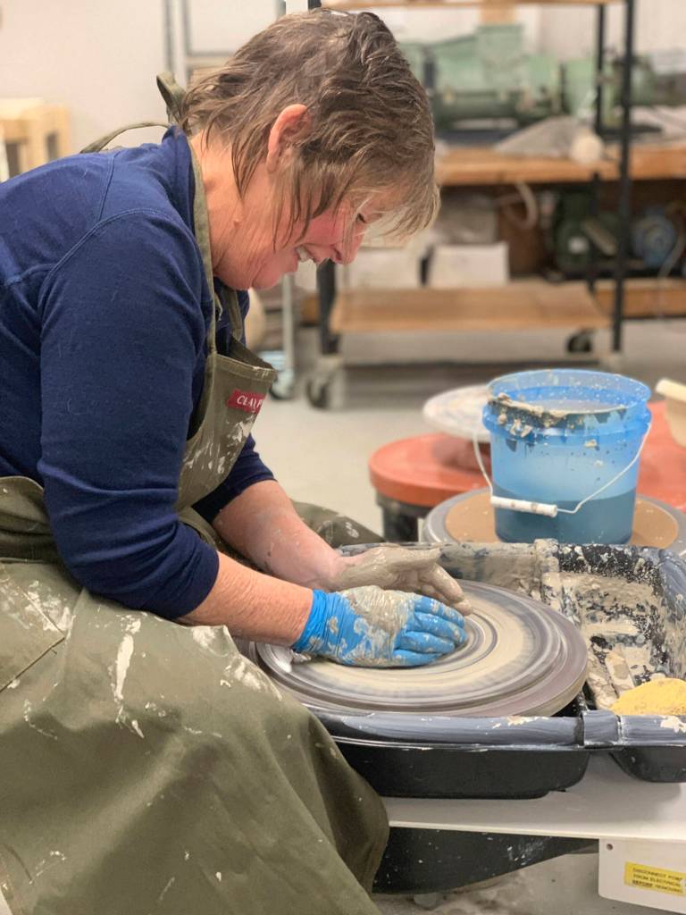 A community member works with clay on a wheel in the ceramics studio at Homer Council on the Arts in Homer, Alaska. (Photo provided by Homer Council on the Arts)