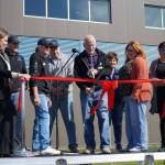 Soldotna Mayor Paul Whitney cuts a ceremonial ribbon for the Soldotna Field House during its grand opening in Soldotna, Alaska, on Saturday, Aug. 16, 2025. (Jake Dye/Peninsula Clarion)