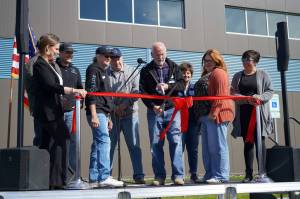 Soldotna Mayor Paul Whitney cuts a ceremonial ribbon for the Soldotna Field House during its grand opening in Soldotna, Alaska, on Saturday, Aug. 16, 2025. (Jake Dye/Peninsula Clarion)