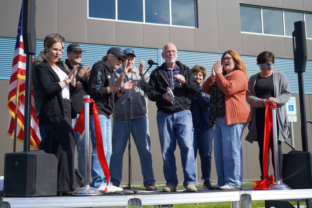 Soldotna Mayor Paul Whitney cuts a ceremonial ribbon for the Soldotna Field House during its grand opening in Soldotna, Alaska, on Saturday, Aug. 16, 2025. (Jake Dye/Peninsula Clarion)