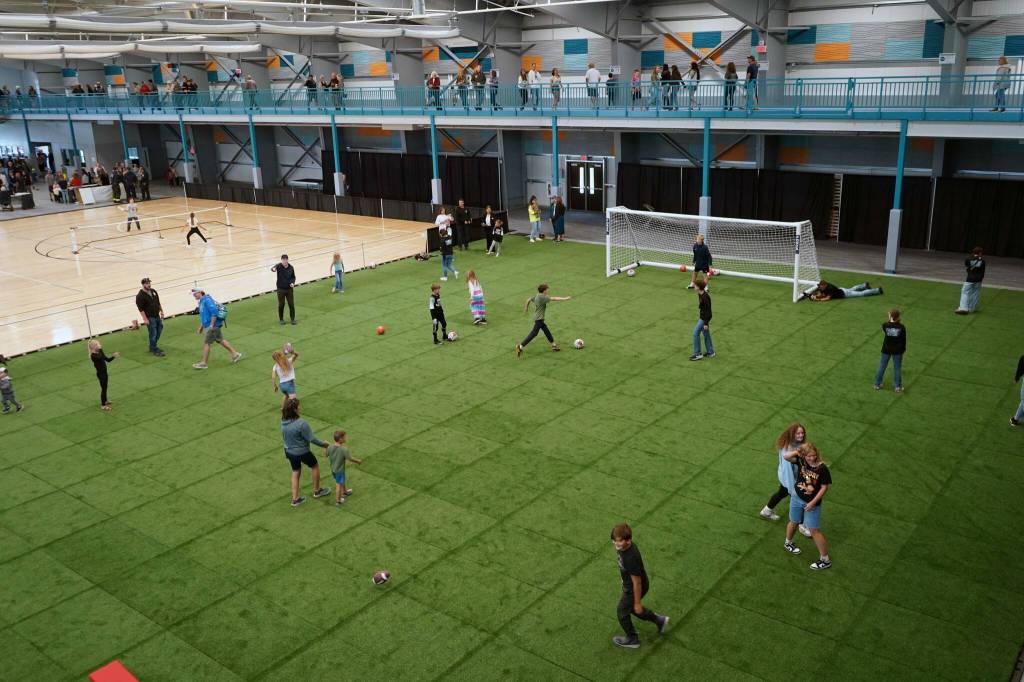 Children and families tour the Soldotna Field House during its grand opening in Soldotna, Alaska, on Saturday, Aug. 16, 2025. (Jake Dye/Peninsula Clarion)