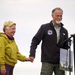 Jan Knutson is accompanied to the podium by Kenai Peninsula Borough Mayor Peter Micciche after winning the Outstanding Individual in Tourism Award during the 2025 Industry Appreciation Day at the Kenai Softball Greenstrip in Kenai, Alaska, on Saturday, Aug. 23, 2025. (Jake Dye/Peninsula Clarion)