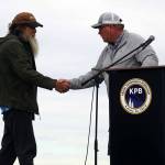 Bill Sleasman is greeted by Kenai Mayor Brian Gabriel after receiving the Outstanding Support for Commercial Fishing Award during the 2025 Industry Appreciation Day at the Kenai Softball Greenstrip in Kenai, Alaska, on Saturday, Aug. 23, 2025. (Jake Dye/Peninsula Clarion)