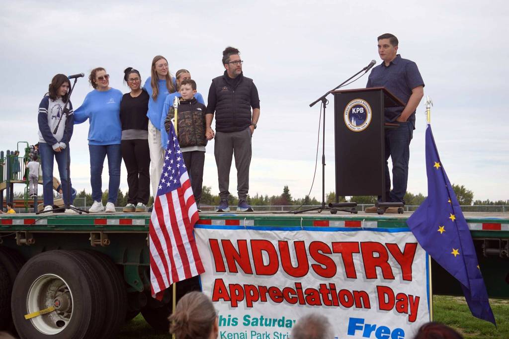 Rep. Justin Ruffridge introduces Dr. Rob McAlpine, who received the Outstanding Business in Health Care Award for Peninsula Pediatric Dentistry during the 2025 Industry Appreciation Day at the Kenai Softball Greenstrip in Kenai, Alaska, on Saturday, Aug. 23, 2025. (Jake Dye/Peninsula Clarion)
