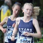 Soldotna's Sophia Jedlicki leads Tania Boonstra at the George Plumley Invite at Palmer High School in Palmer, Alaska, on Saturday, Sept. 6, 2025. (Photo by Jeremiah Bartz/Frontiersman)
