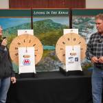 Kenai Chamber of Commerce Executive Director Samantha Springer and Kenai Mayor Brian Gabriel prepare to spin the wheels and determine the magic weight on the first day of the Ninth Annual Kenai Silver Salmon Derby at the Kenai Chamber of Commerce in Kenai, Alaska, on Tuesday, Sept. 9, 2025. (Jake Dye/Peninsula Clarion)