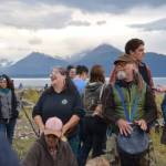 Beth Carroll and John Sheipe drum around a campfire on Sunday, Sept. 7, 2025, at Mariner Park in Homer, Alaska, in preparation for the burn. (Chloe Pleznac/Homer News)