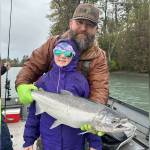 Nathaniel and Abigail Craig, stand with a coho during the Ninth Annual Kenai Silver Salmon Derby on the Kenai River near Kenai, Alaska. (Photo provided by Nathaniel Craig)