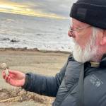 Archaeologist Rick Knecht holds a human figure that he found on the beach near the village of Quinhagak on Oct. 24, 2025. Photo courtesy Alice Bailey