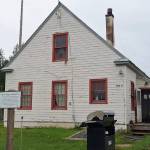 The historic marker in front of this building at 502A Overland Avenue in Kenai identifies the structure as the former headquarters of the Kenai National Wildlife Refuge and the site of the former Agricultural Experiment Station, 1899-1908. Photo by Clark Fair