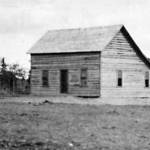 Images from the Rasmuson Library historical archives at the University of Alaska Fairbanks
Kenai Station superintendent Hans P. Nielsen finished construction of his quarters/office building in early 1901. Seen here that year, the log structure is in its earliest stage of completion, with its upper-story window and its stove pipe.