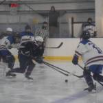 Homer and Soldotna hockey players battle for the puck during the Carlin Cup home varsity game on Saturday, Dec. 13, 2025, at the Kevin Bell Arena in Homer, Alaska. (Delcenia Cosman/Homer News)