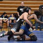 A Nikiski wrestler goes to pin a Ninilchik athlete during the regional Kachemak Conference Wrestling Championships on Saturday, Dec. 13, 2025, at Homer High School in Homer, Alaska. (Delcenia Cosman/Homer News)