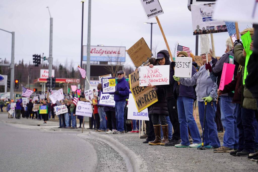 Protesters stand along the Sterling Highway in Soldotna, Alaska, participating in the "Remove, Reverse, Reclaim" protest organized by Many Voices and Kenai Peninsula Protests as part of the nationwide 50501 effort on Saturday, April 5, 2025. (Jake Dye/Peninsula Clarion)