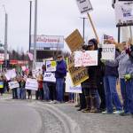 Protesters stand along the Sterling Highway in Soldotna, Alaska, participating in the "Remove, Reverse, Reclaim" protest organized by Many Voices and Kenai Peninsula Protests as part of the nationwide 50501 effort on Saturday, April 5, 2025. (Jake Dye/Peninsula Clarion)