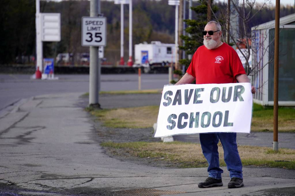 Brian Krauklis, a Sterling Elementary School teacher, stands during a protest against the possible closure of Sterling Elementary School along the Sterling Highway in Soldotna, Alaska, on Saturday, May 3, 2025. (Jake Dye/Peninsula Clarion)