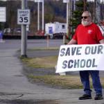 Brian Krauklis, a Sterling Elementary School teacher, stands during a protest against the possible closure of Sterling Elementary School along the Sterling Highway in Soldotna, Alaska, on Saturday, May 3, 2025. (Jake Dye/Peninsula Clarion)
