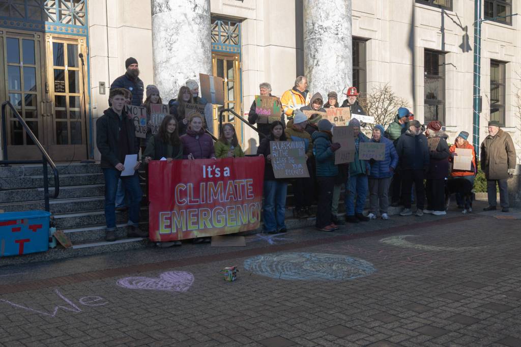 Dozens of Juneauites gather on the steps of the Alaska State Capitol building on Jan. 24, 2026 to participate in an anti-LNG pipeline protest led by the Juneau-Douglas High School: Yadaa.at Kalé chapter of Alaska Youth for Environmental Action. (Chloe Anderson / Juneau Empire)