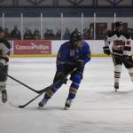 Flanked by JDHS freshmen Manu Adams, left, and Paxton Willoughby, right, Homer junior Berend Pearson looks for a pass from a teammate. The Crimson Bears and the Mariners faced off at the Treadwell Arena in Juneau following the Bears senior night ceremony on Friday, Jan. 23.<ins>, 2026</ins>