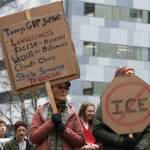 Protesters hold signs at the Dimond Courthouse plaza during an anti-ICE protest on Jan. 29, 2026. (Chloe Anderson/Juneau Empire)