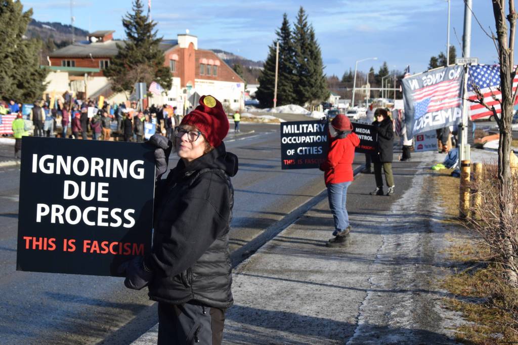 Protesters line up on the sidewalk along Pioneer Avenue and carry This is fascism signs during the ICE OUT demonstration on Sunday, Feb. 1, 2026, at WKFL Park in Homer, Alaska. (Delcenia Cosman/Homer News)