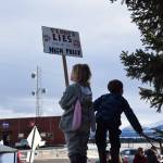A young protester carries a No Kings sign during the ICE OUT demonstration on Sunday, Feb. 1, 2026, at WKFL Park in Homer, Alaska. (Delcenia Cosman/Homer News)