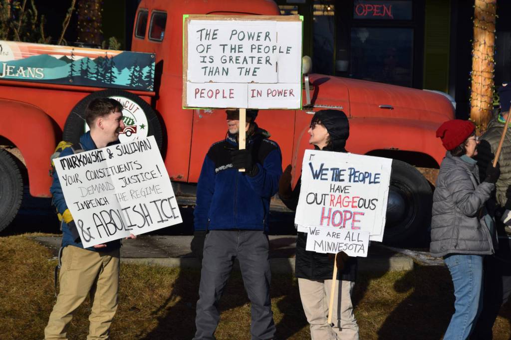 Community members carry signs protesting ICE during the ICE OUT demonstration on Sunday, Feb. 1, 2026, at WKFL Park in Homer, Alaska. (Delcenia Cosman/Homer News)
