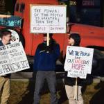 Community members carry signs protesting ICE during the ICE OUT demonstration on Sunday, Feb. 1, 2026, at WKFL Park in Homer, Alaska. (Delcenia Cosman/Homer News)