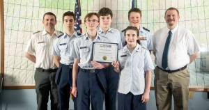 The Kenai Composite Squadron of the Alaska Wing, Civil Air Patrol is pictured on Jan. 26, 2026 with the first place state award from the CyberPatriot National Youth Cyber Defense Competition. Photo courtesy of Nickolas Torres