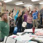 Simon Nissen, Kenai Central choir teacher and founder of the Kenai Peninsula Singers, warms up the singers at Kenai Central before a Monday rehearsal for the Evening of Christmas show. (Photo by Jeff Helminiak/Peninsula Clarion)