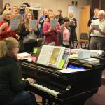 Members of the Kenai Peninsula Singers perform during a rehearsal on Dec. 11. The Peninsula Singers and Redoubt Chamber Orchestra will perform together in the 2017 Evening of Christmas on Friday, Dec. 15. (Photo by Erin Thompson/Peninsula Clarion)