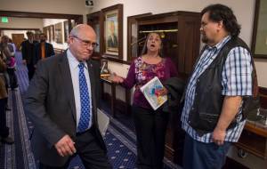 Nancy Keen, center, and Alfie Price, right, sing a Nisga&rsquo;a prayer song as senators, including Sen. John Coghill, R-North Pole, make their way to the Senate chambers for a session on Wednesday, April 25, 2018. Senators were to vote on a resolution urging Gov. Bill Walker to issue an administrative order recognizing a linguistic emergency for Alaska Native languages. (Michael Penn | Juneau Empire)